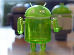 Android-Figur aus Plastik steht auf einem Tisch.