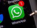 Das WhatsApp-Symbol ist auf dem Display eines iPhones zu sehen. 
