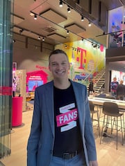 Georg Schmitz-Axe, Leiter Telekom Partner, stellt die neuen T-Shirts mit dem Telekom-Slogan vor.